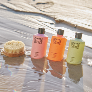 the body brush and shower oils on beach