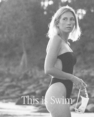 This is swim, girl on beach holding dive mask